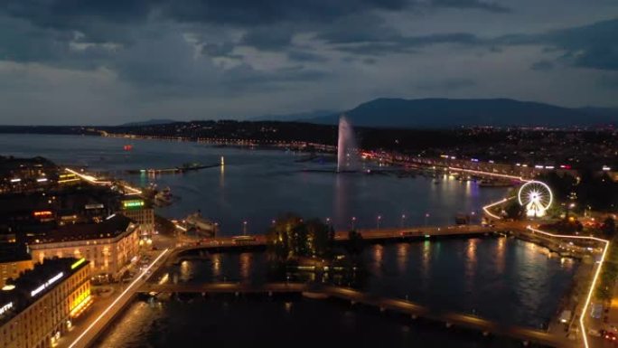 夜间照明飞行在日内瓦市中心湖滨湾空中全景4k瑞士