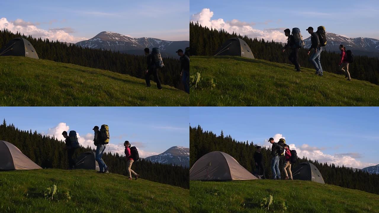 带着背包的旅游团去山区的帐篷镇。