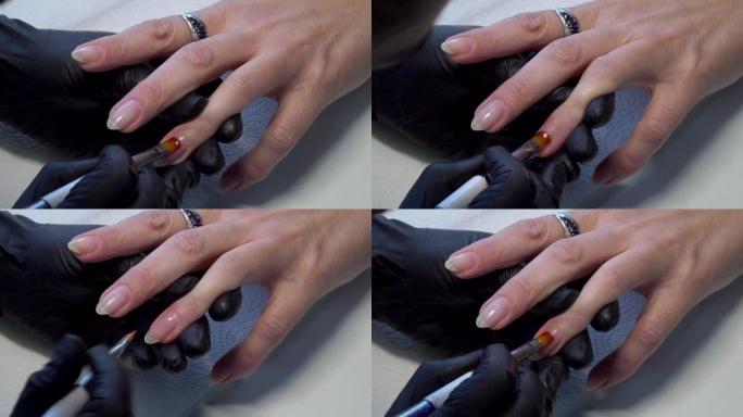 女性手修指甲。涂清漆基底。美甲指甲油。美丽的美甲特写。美丽女性双手涂抹透明指甲油的特写。指甲护理和修