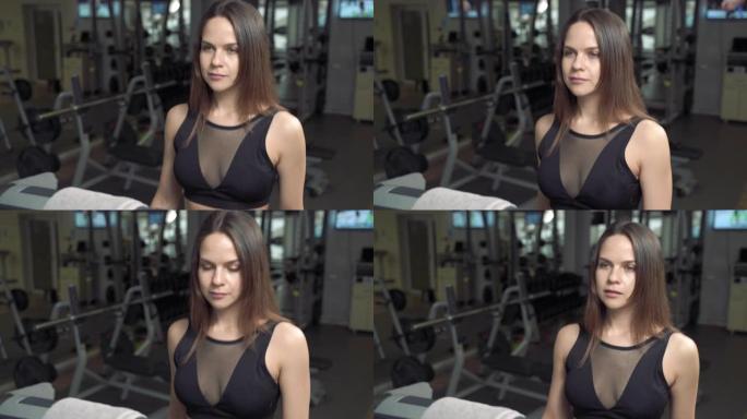 健身女子在健身房跑步机上进行有氧训练的肖像。健身中心使用跑步机的运动女孩。