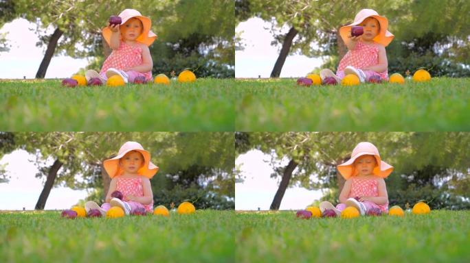 幼儿园背景。健康开朗的孩子在户外玩耍。美丽的女孩在院子里玩水果。夏季收获。秋收概念。