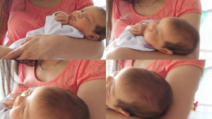 新生儿在母亲的怀抱中入睡的特写
