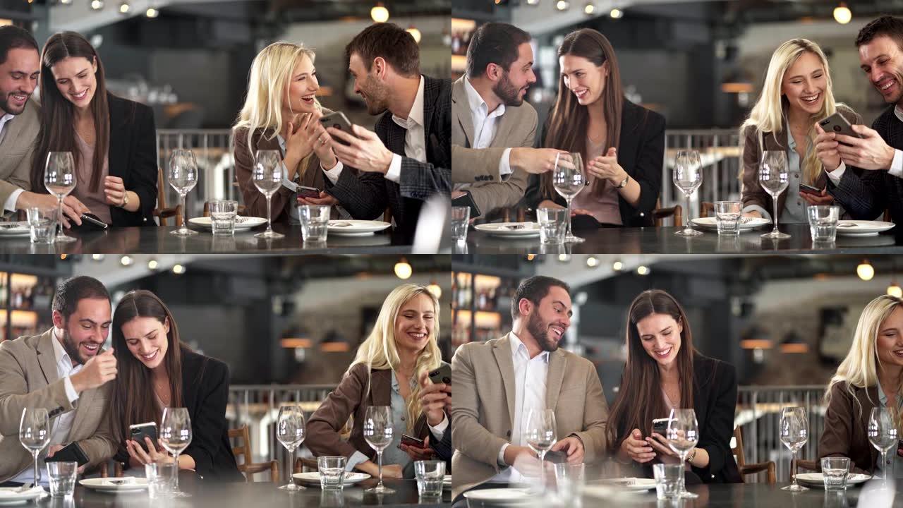 两对夫妇在餐厅的午休时间使用智能手机