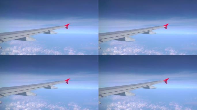 飞机飞行。飞机的翅膀在日落天空的云层上飞行。从飞机的窗户看。飞机，飞机。乘飞机旅行。4K超高清视频