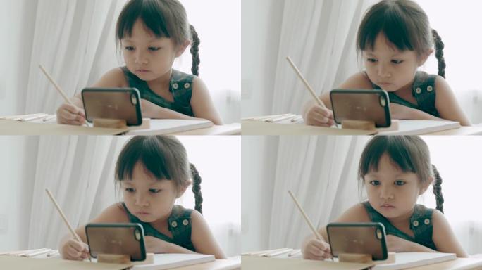 泰国女婴做作业小朋友写字看手机