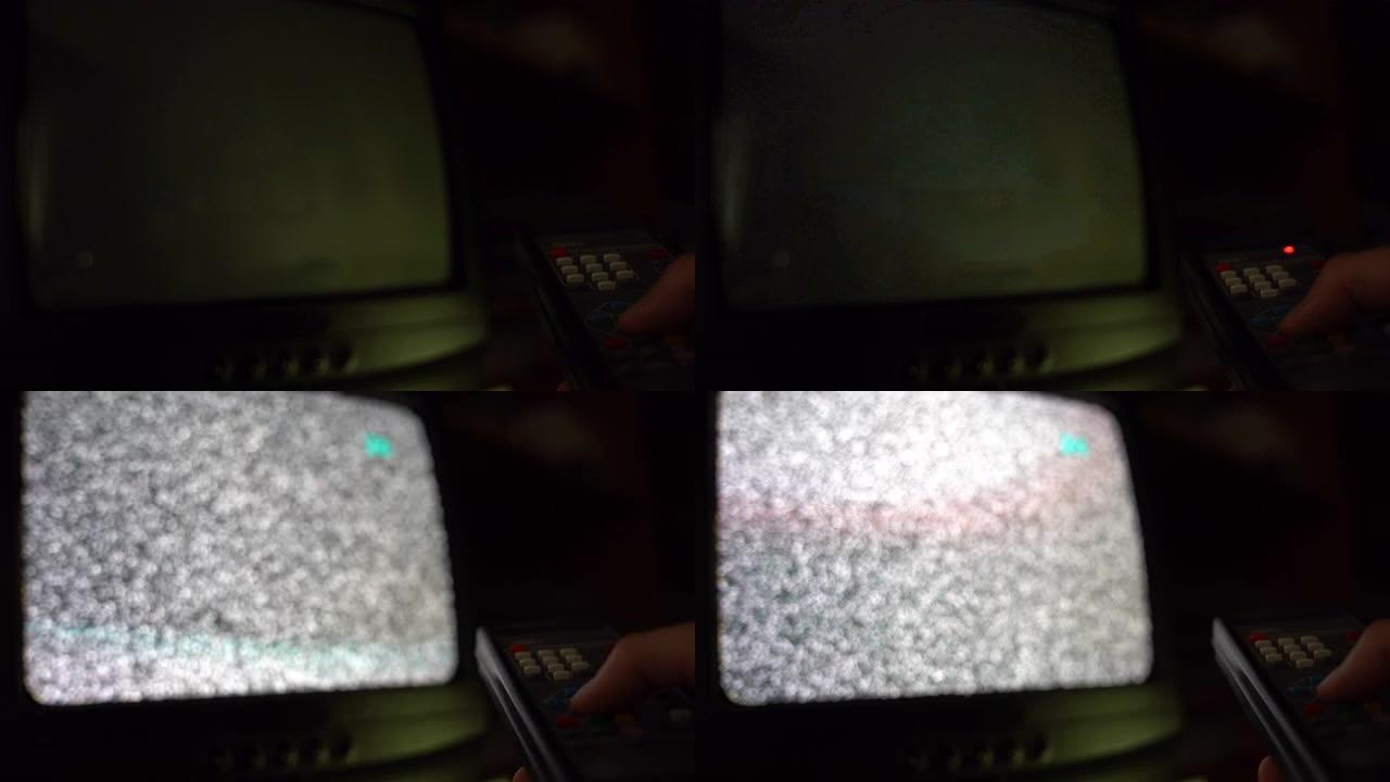 旧复古遥控器在男性手中，男人在黑暗中改变老式电视上的频道。模糊的噪音干扰屏幕和毛刺。复古电视概念