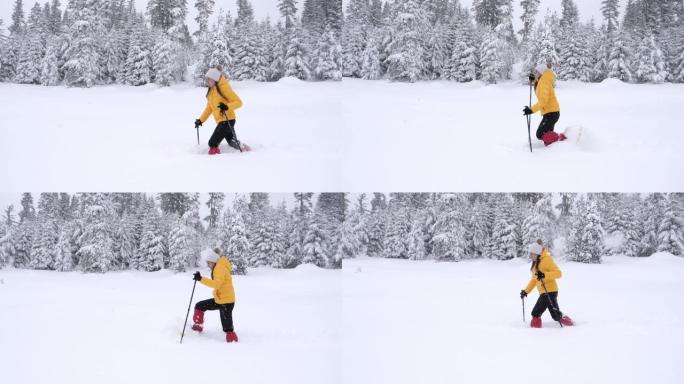 冬季旅行者。一名年轻女子的慢动作游客雪鞋在深雪中行走，享受着冬日的高山。