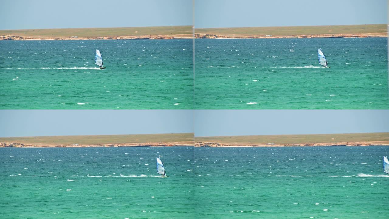 在阳光明媚的夏日，男人在水中滑浪风帆。射。阳光明媚的日子里美丽的海景和风帆冲浪