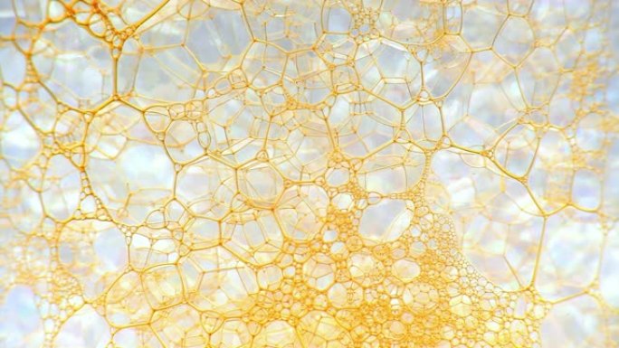 彩色肥皂泡沫与爆裂气泡背景。摘要生物结构，大分子模式。橙色墨水填充了一团在液体中形成的白色小气泡。自