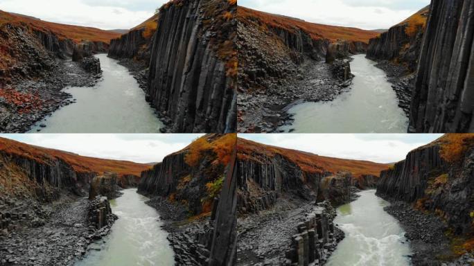 无人机飞越冰岛黑色玄武岩柱峡谷
