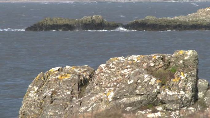 在大风天，苏格兰海滩上的岩石波浪