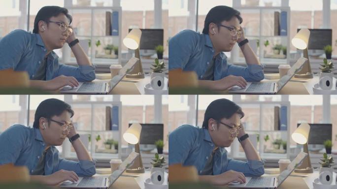 亚洲上班族使用笔记本电脑并入睡