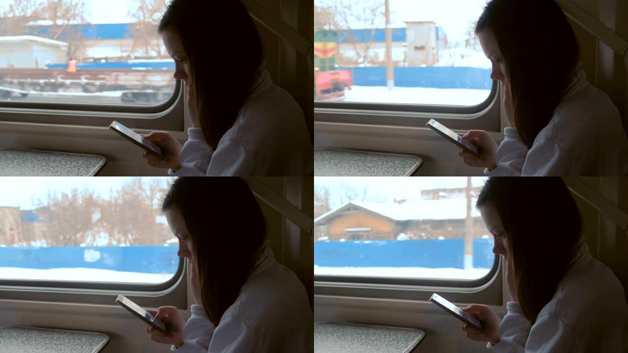 疲惫的年轻女子在火车上看手机视频。