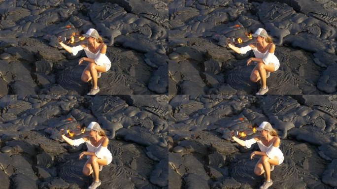 在夏威夷基拉韦厄火山与熔岩合影的徒步旅行女孩