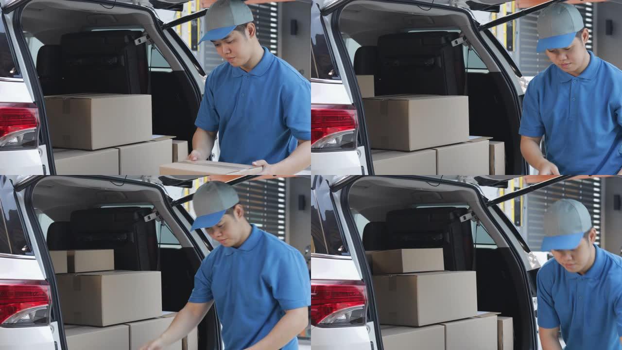 送货员将包裹邮筒装在纸箱中，并在交付给客户之前检查包裹邮筒的库存。送货上门的概念。