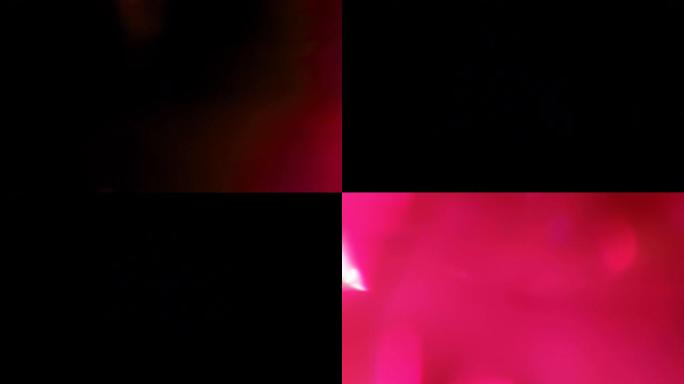 黑色背景上有粉红色的光线泄漏。叠加。照片过滤器。过渡