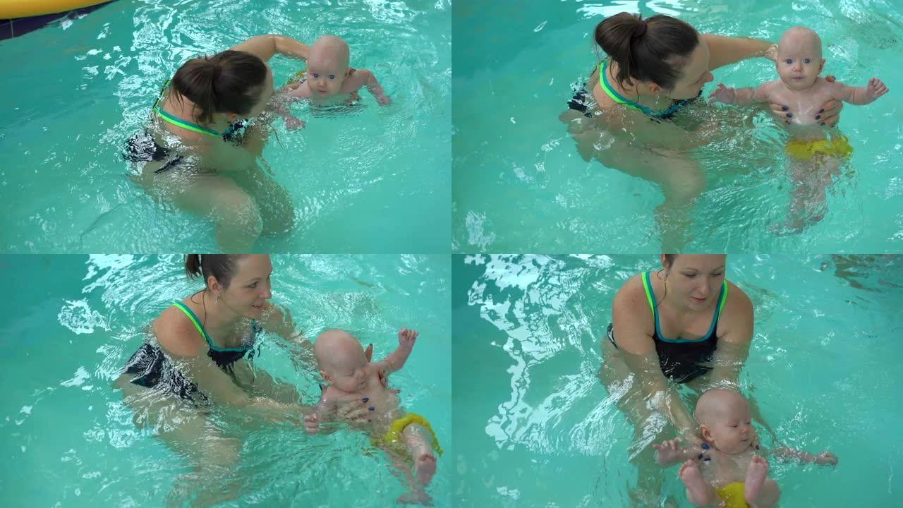 年轻的妈妈和她的小女儿在游泳池里做水程序。新生儿保健用水程序