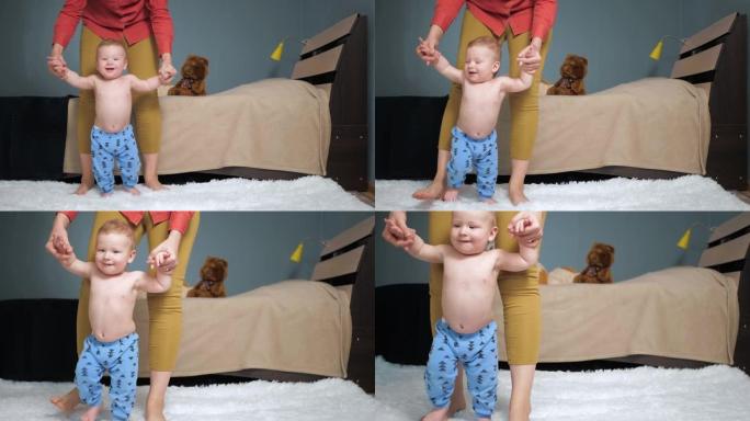 妈妈带领婴儿牵着他的手走向镜头。第一个婴儿台阶概念。慢动作