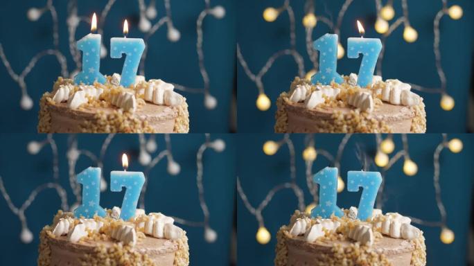 蓝色背景上有17个数字蜡烛的生日蛋糕。蜡烛吹灭了。慢动作和特写视图