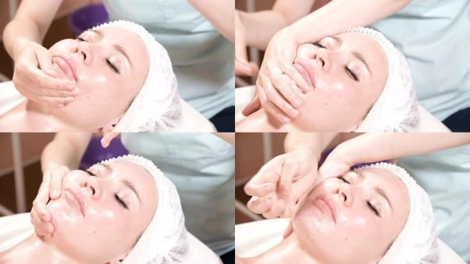 女孩美容师戴着面具和手套为一个迷人的女人做健康的面部按摩。新一代美容按摩