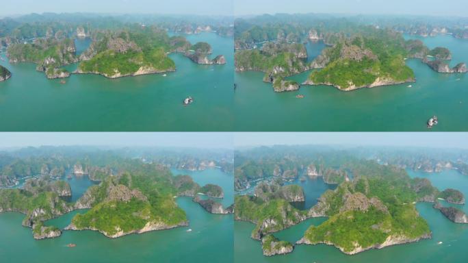 空中: 独特的飞越下龙湾蓝河湾猫巴岛，越南著名的旅游目的地。晴朗的蓝天。大海中的石灰岩山峰。