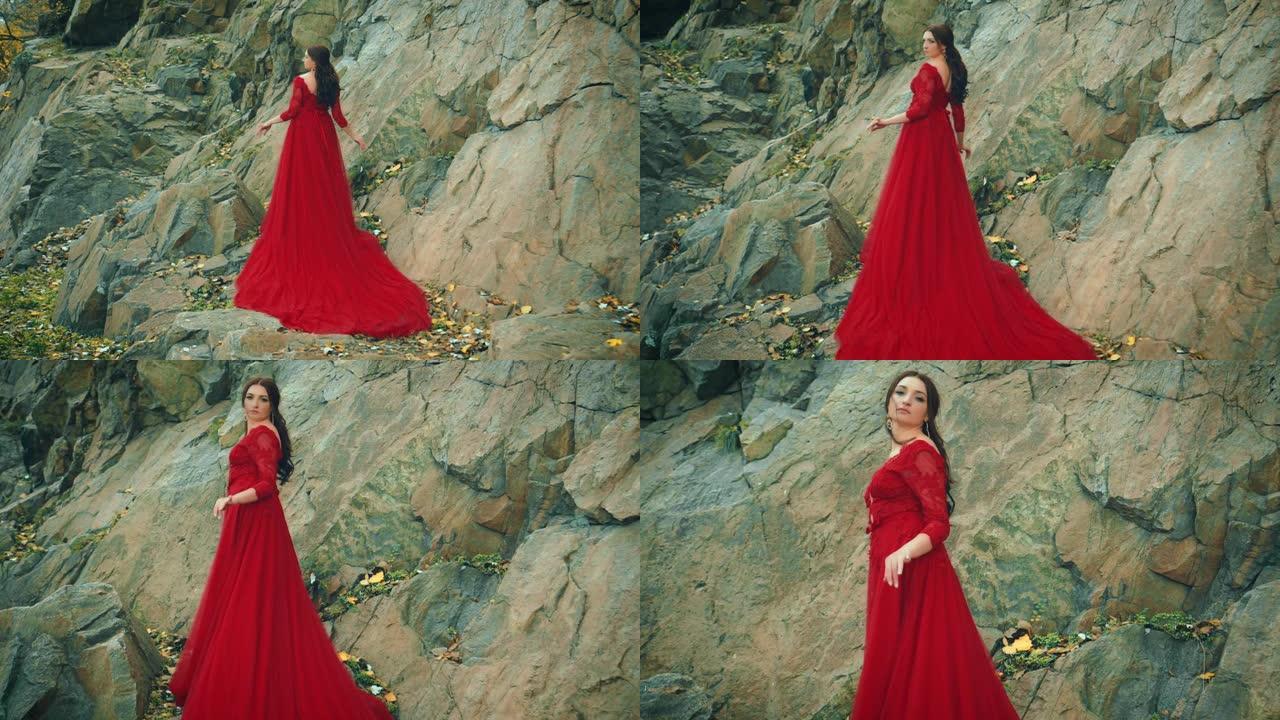 穿着红色连衣裙的女人长火车岩石山。后视图向后看
