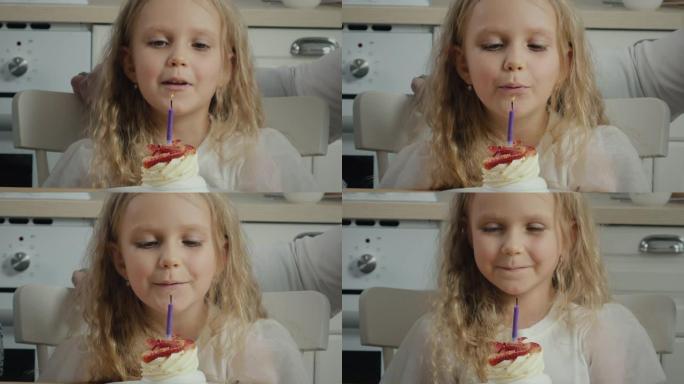 生日女孩在蛋糕上吹蜡烛许愿