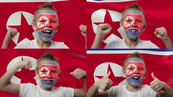 朝鲜国旗背景上的快乐粉丝。有着民族色彩的脸的快乐男孩。