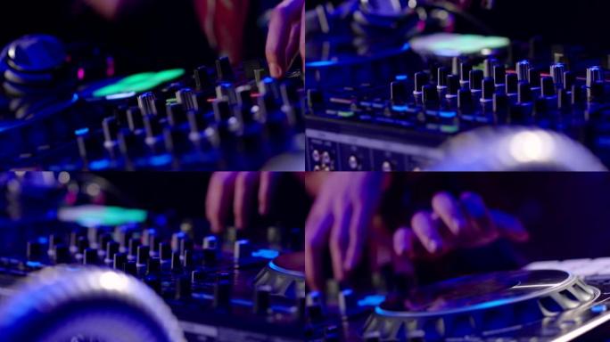 夜总会迪斯科派对Dj调音台控制器的特写。DJ手触摸按钮和滑块播放电子音乐。DJ手在乙烯基板上混合和刮