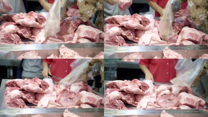 顾客在超市采摘猪肉。