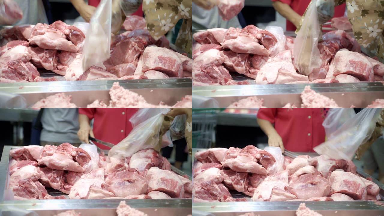 顾客在超市采摘猪肉。