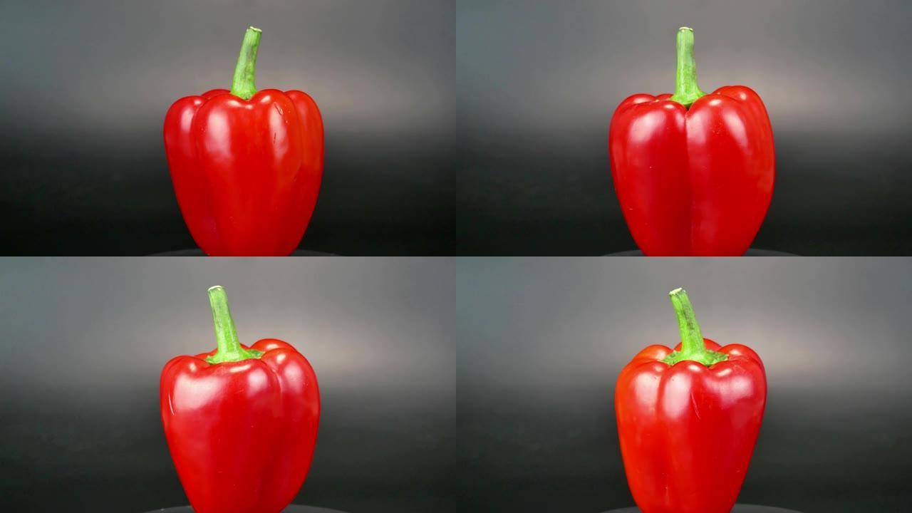 红辣椒在黑色背景上旋转。食品。视频。
