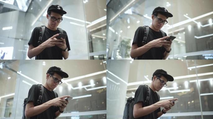 亚洲男子自由职业者在午夜城市使用智能手机