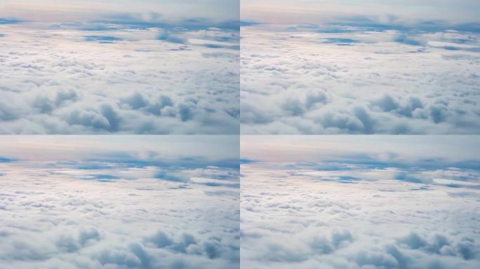 飞越柔和的光云。透过飞机窗户看