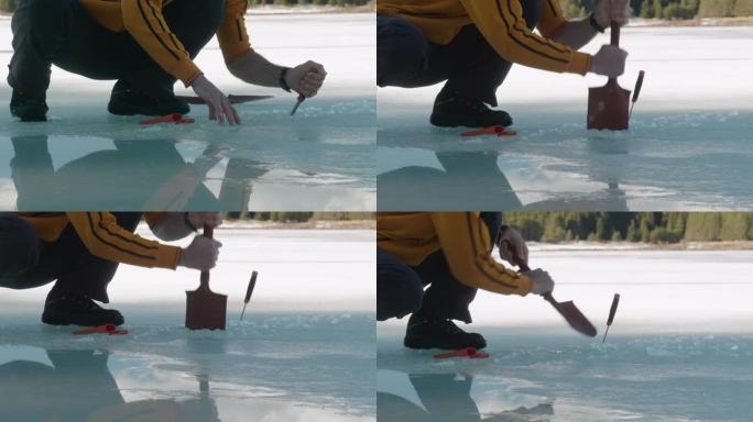打破僵局。一个英俊的男人站在冰冻的湖面上。