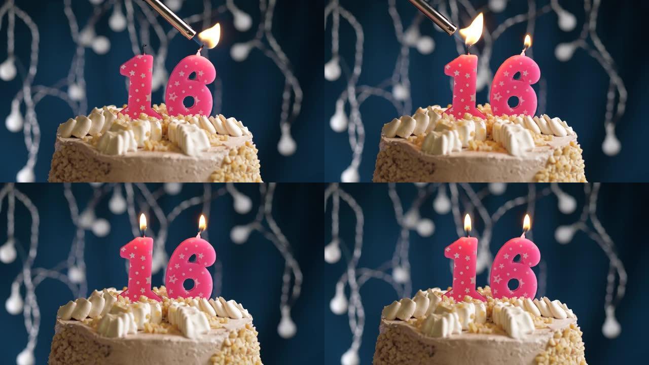 蓝色背景上有16号粉色蜡烛的生日蛋糕。蜡烛着火了。慢动作和特写视图