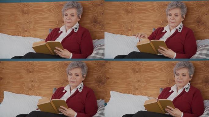 老年妇女躺在床上看书，然后才有睡眠时间
