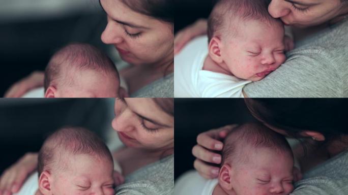 母亲抱着熟睡的新生婴儿亲吻爱的关怀和感情