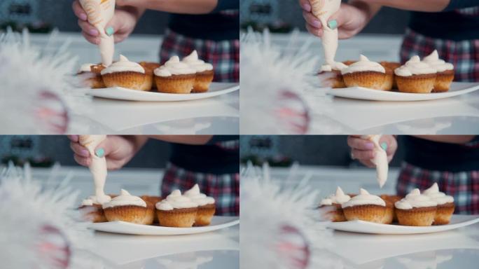 用白色奶油装饰纸杯蛋糕。糖果店使用烹饪袋为派对制作松饼