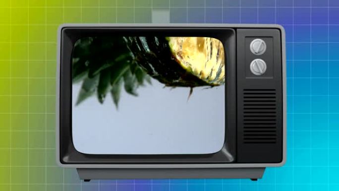 屏幕上有菠萝的旧电视，背靠网格图案背景
