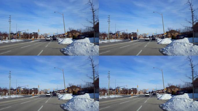汽车在红灯处等待，在城市街十字路口右转。车辆病人，冬天下雪时在城市道路右转。