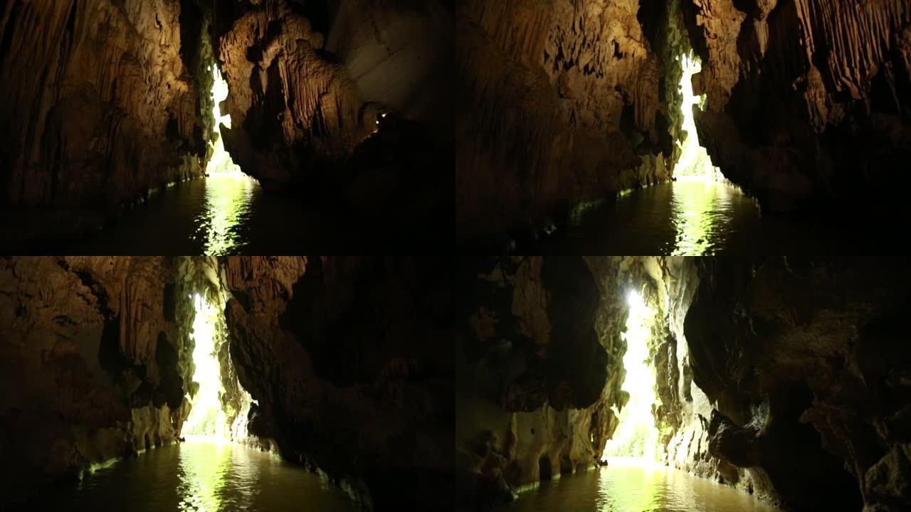 穿过充满水的黑暗洞穴向外面明亮的光线移动