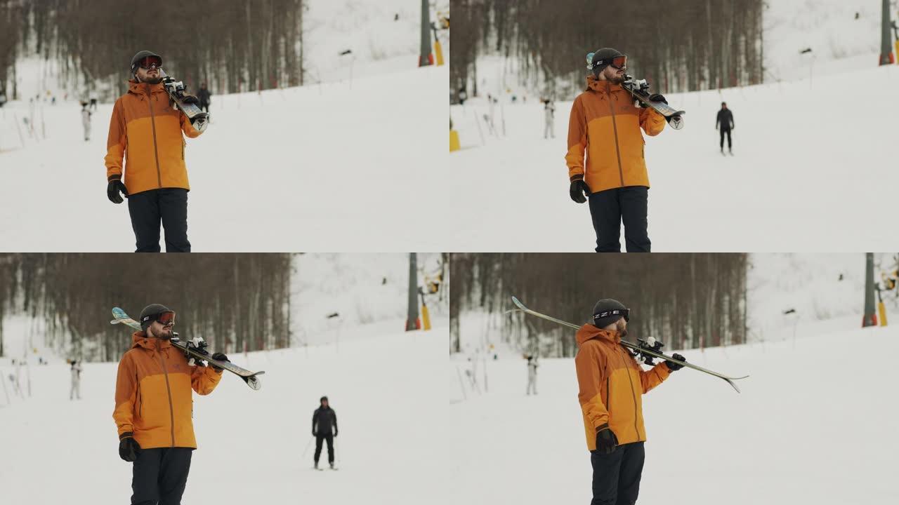 职业运动员站在小山上，看着远处，手里拿着滑雪板。冬季运动。股票视频
