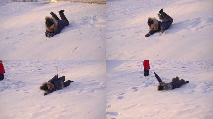 小男孩和他妈妈在雪地里玩耍。慢动作镜头