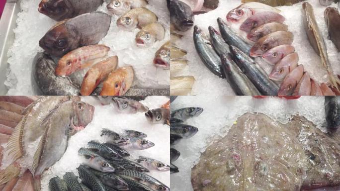 在鱼贩商店的冰床上展示许多各种各样的鲜鱼
