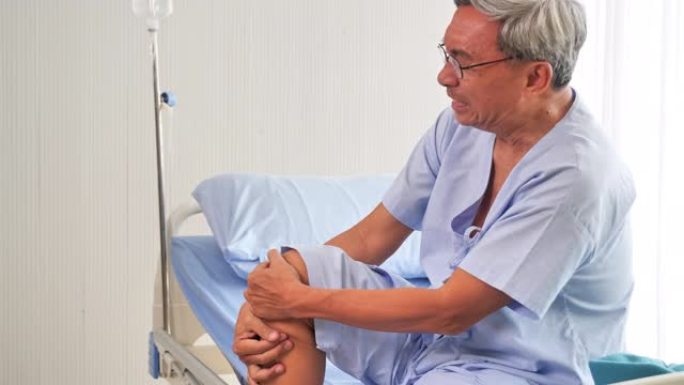 患者资深亚裔男子在医院病床上感到剧烈疼痛。