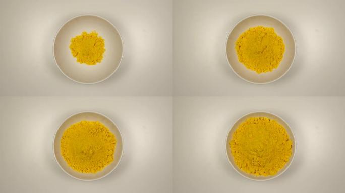俯视图: 姜黄素粉填充白色碗-停止运动