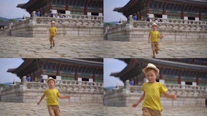 小男孩参观韩国首尔的古代宫殿。去韩国旅游概念。慢动作镜头