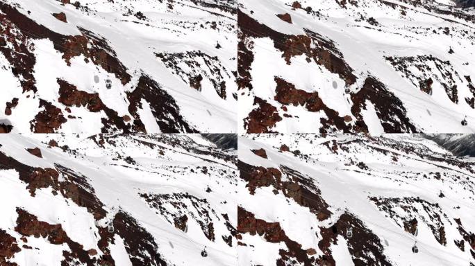 冬季时，在Elbrus度假胜地的高加索高山上的缆车和滑雪场的鸟瞰图。跟踪客舱索道