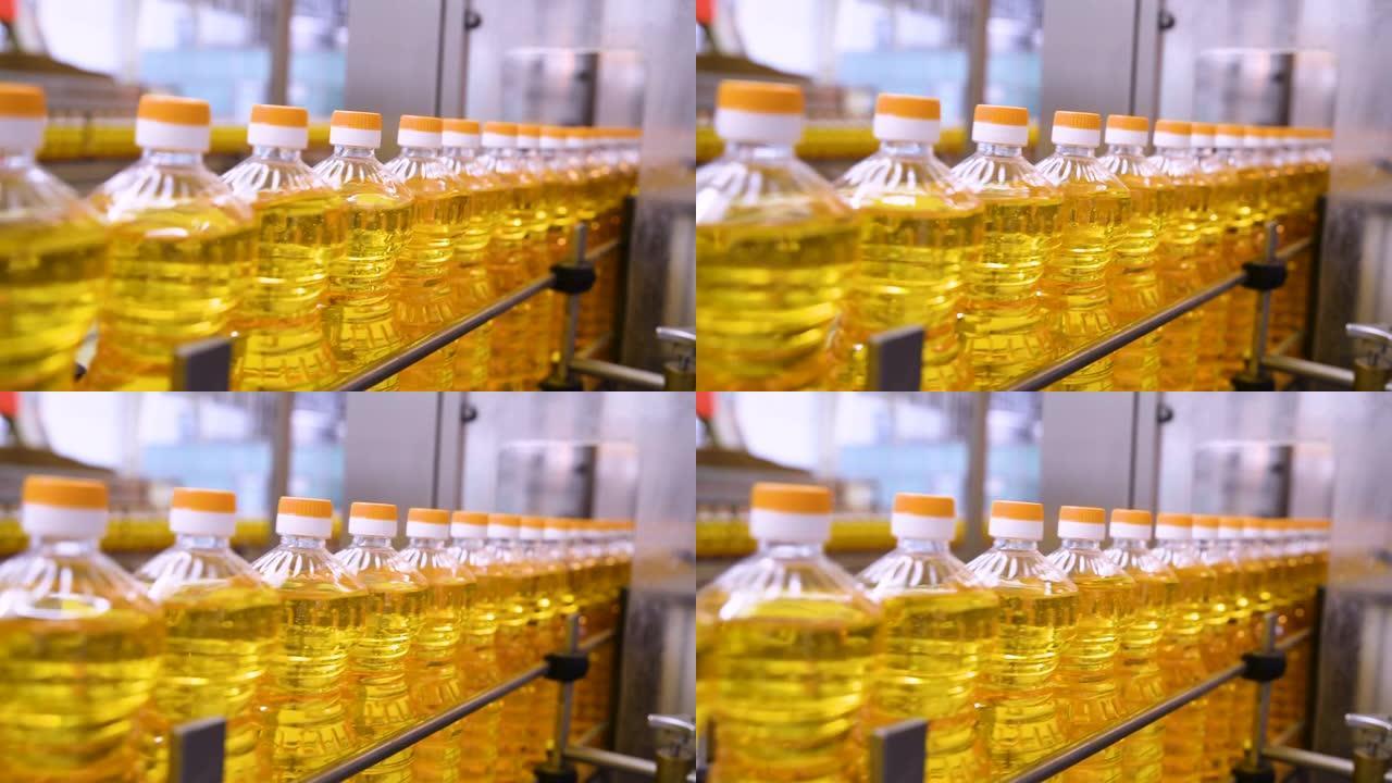 瓶子里的葵花籽油在生产线上移动。葵花籽油生产厂